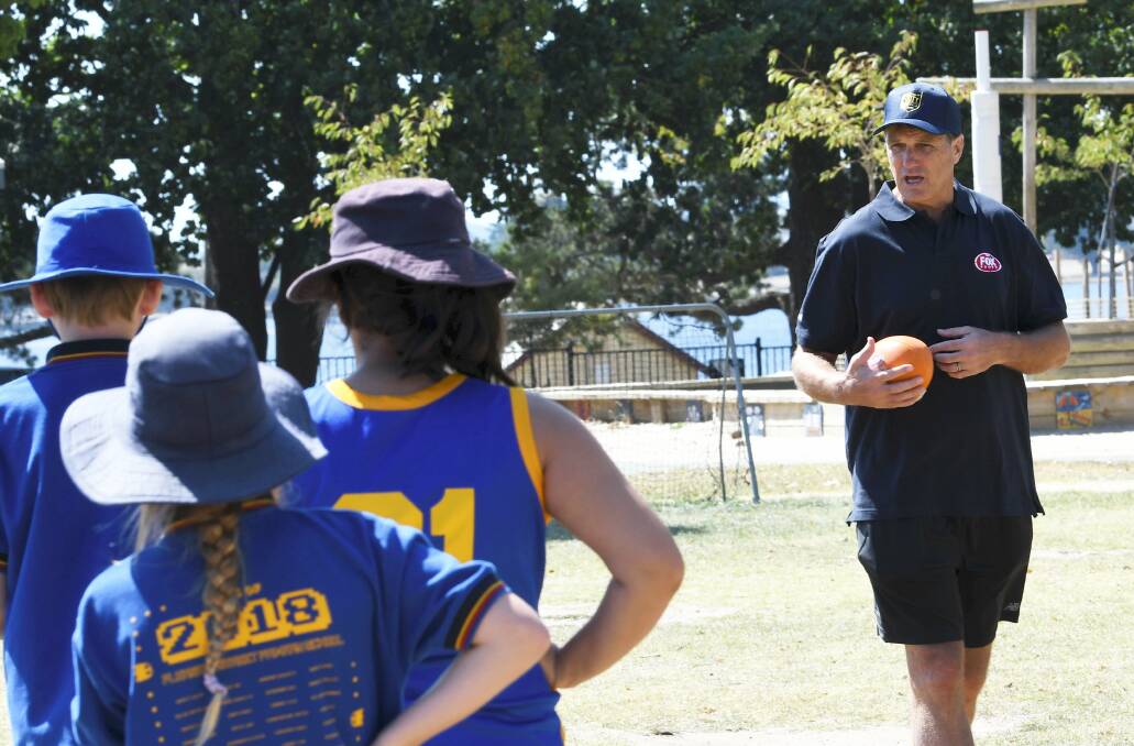 SHOWING THE ROPES: Sydney premiership coach Paul Roos runs a clinic at Pleasant Street Primary School on Tuesday. Picture: Lachlan Bence.