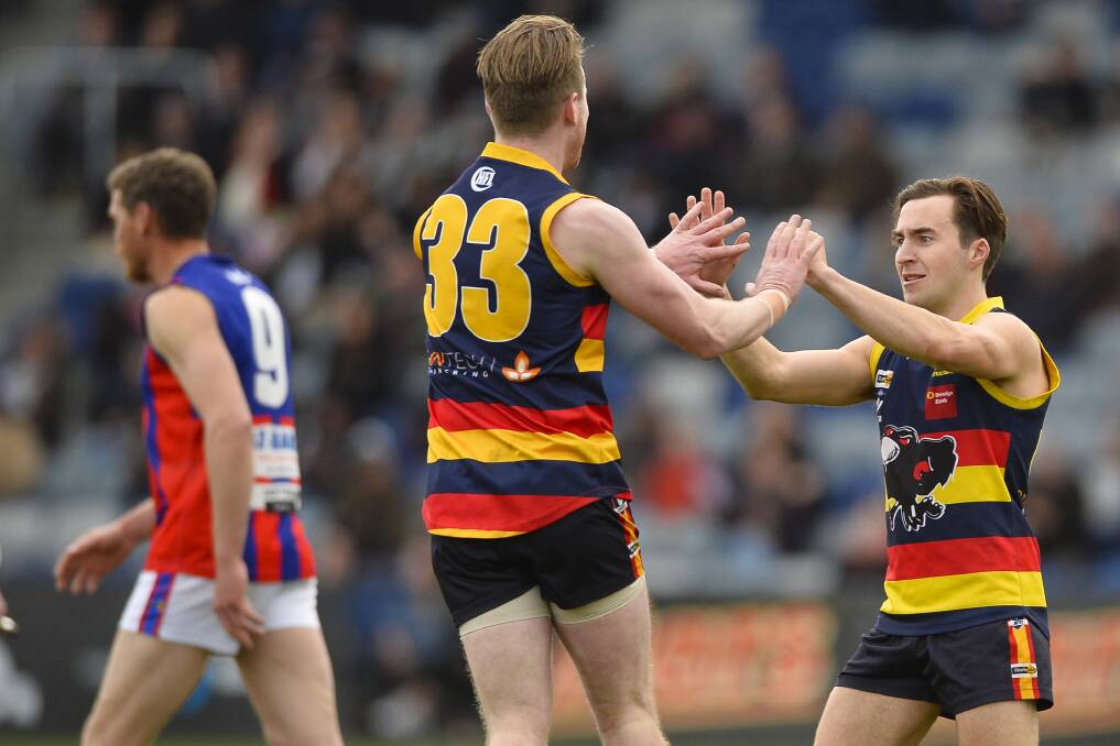 HIGH FIVES: Beaufort's Tim Haase and Rupert Sangster react to one of the team's goals. The Crows got close, but were eventually beaten by 18 points.