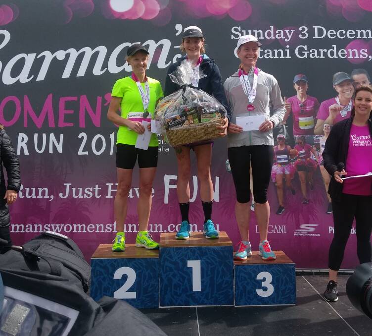 WINNER: Tash Fraser (centre) stands on the podium after winning the Carman's Women's Fun Run half marathon. She clocked a time of 1:22:56.8hr.