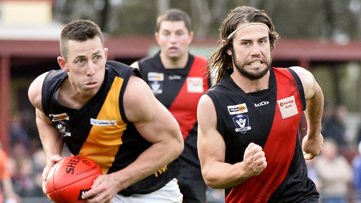 IN PURSUIT: Buninyong's Matt Caris tries to chase down Springbank danger man Billy Driscoll. The Tigers star finished the day with three goals in a top display.