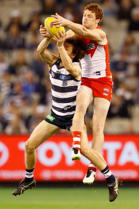 CONTEST: Cowan battles for the ball against Sydney's Gary Rohan.