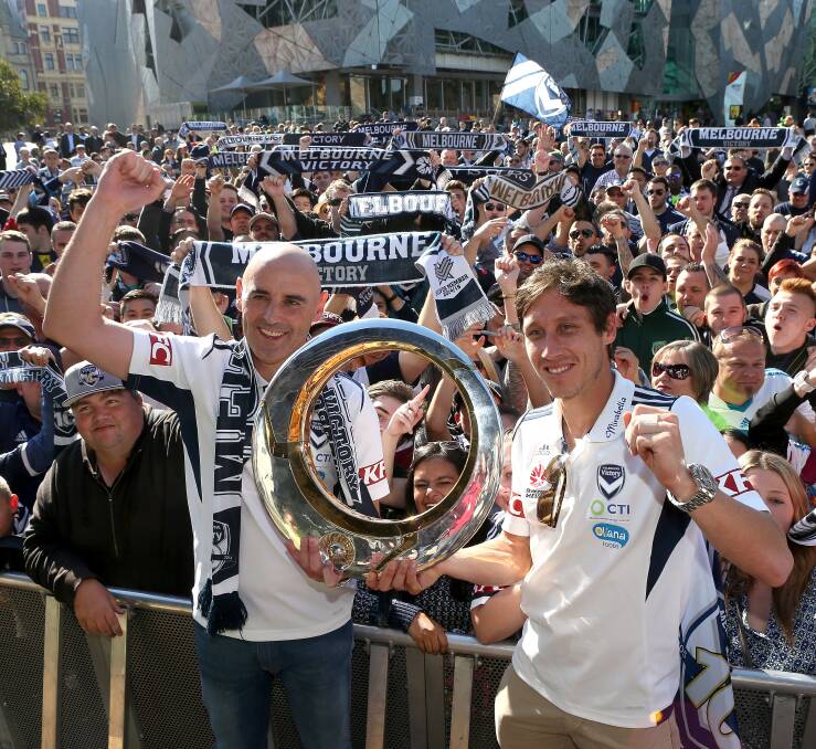CHAMPIONS: Melbourne Victory coach Kevin Muscat and captain Mark Milligan during grand final celebrations earlier this year. Picture: Getty Images.