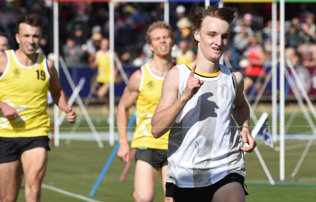 NUMBER ONE: Stawell youngster Tom Walker celebrates as he crosses the line to win the backmarkers' 1600m handicap. Picture: Lachlan Bence.