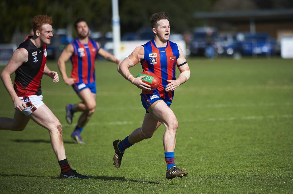 ON THE CHARGE: Hepburn's Brad McKay sends his team forward during Sunday's hard-fought victory against Buninyong. Pictures: Luka Kauzlaric.