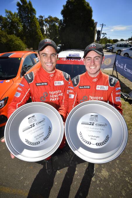 ALL SMILES: John McCarthy and Harry Bates show off the spoils of their win in the 2018 Eureka Rally. The pair also won the race last year.