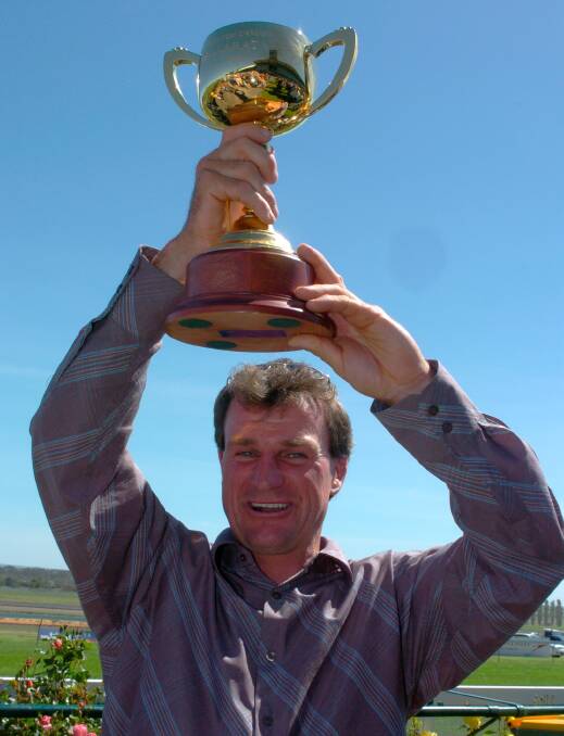 FLASHBACK: Darren Weir holds the Ballarat Cup aloft after winning it in 2004 with Just The Part. Weir could have five starters in the race on Saturday.