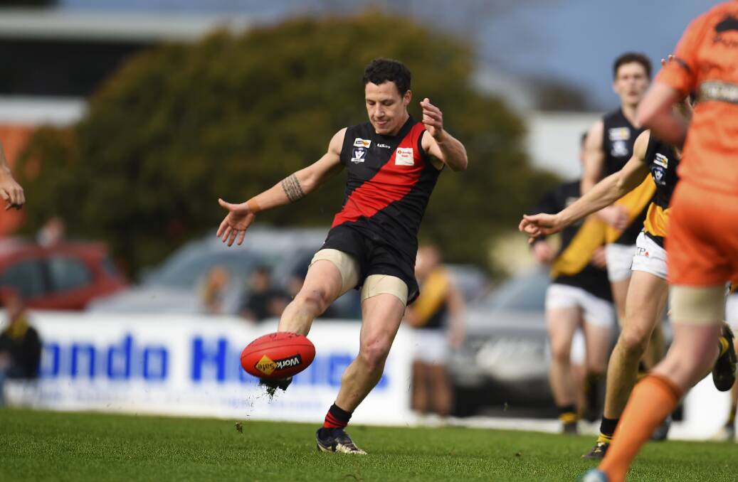 KICK: Buninyong's Josh Renga throws one on the boot to send his side forward on Saturday at Alfredton Recreation Reserve. Pictures: Luka Kauzlaric, Dylan Burns.