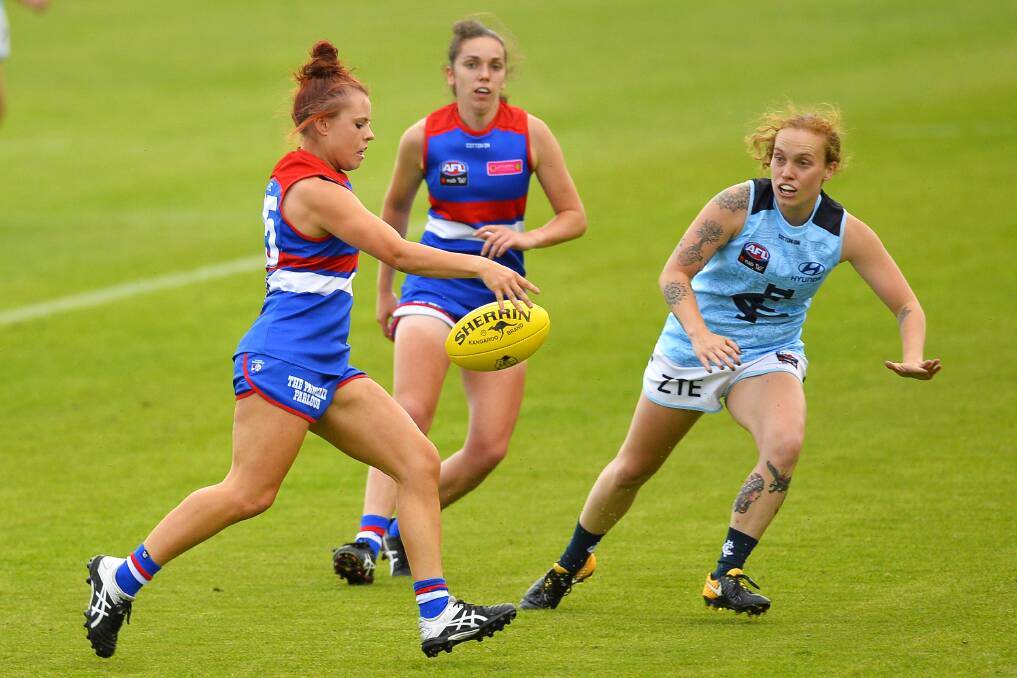 NEW COLOURS: Western Bulldogs recruit Jenna Bruton, who is from Trentham, gets a kick away in Ballarat on Saturday evening.