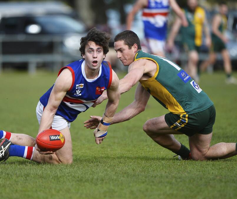 HANDPASS: Sebastian Walsh, from Daylesford, scans for options while Mark Gunnell, from Gordon tries to interfere.