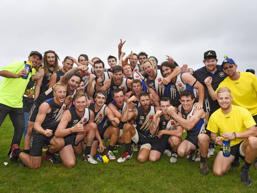 CELEBRATIONS: Smythesdale players and supporters pose for a premiership-style photo following the final siren on Saturday afternoon.