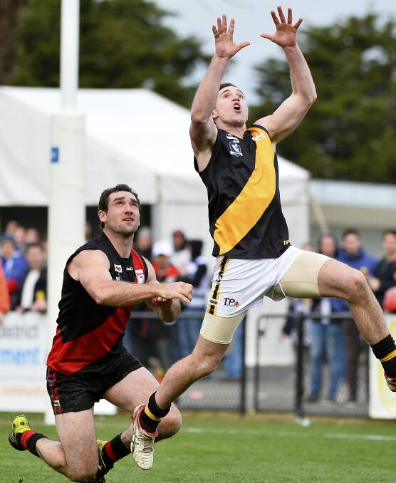 MY BALL: Tigers forward Tom Eltringham gets clear of Buninyong defender Adam Scott. Eltringham didn't have a huge impact on the game, but still booted a major.