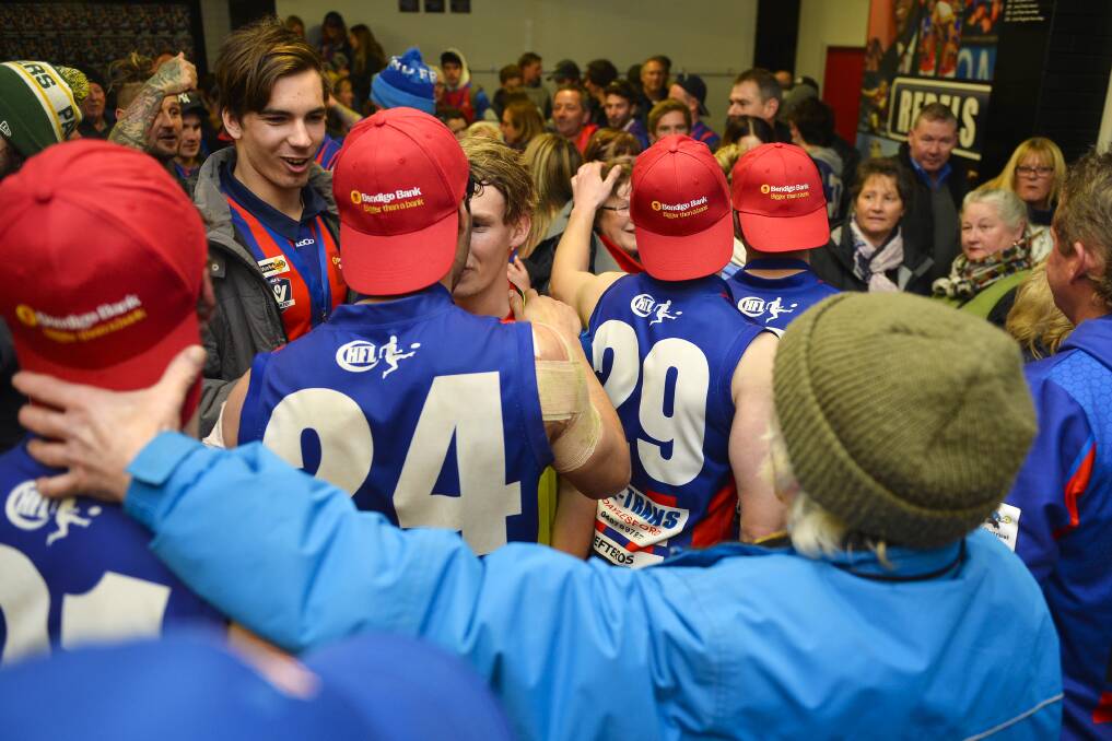 HAPPY TIMES: Hepburn players and supporters celebrate the senior grand final victory over Beaufort in the rooms at Mars Stadium.