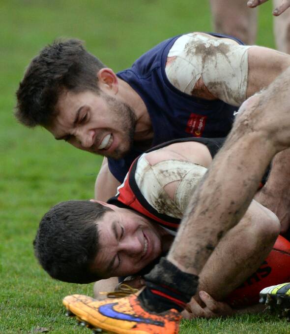 YOU'RE GOING NOWHERE: Ballan's Jackson Kew holds Buninyong's Sam Turner in a tackle during Saturday's clash. Pictures: Kate Healy. Story: David Bilbrough.