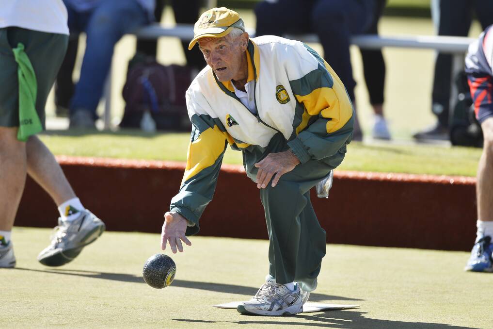 VICTORS: Buninyong's Bill Innes sends down a bowl in the division one grand final. His rink won by five shots to help the team record an overall 117-101 triumph.