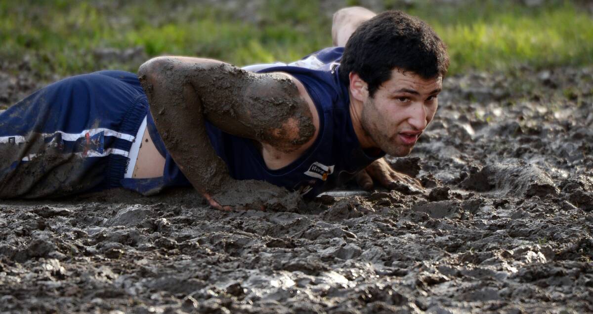 MUD BATH: The Blues' Dylan Galea gets a feel for the Ballan surface during last Saturday's round 17 Central Highlands Football League clash with Hepburn. Picture: Kate Healy.