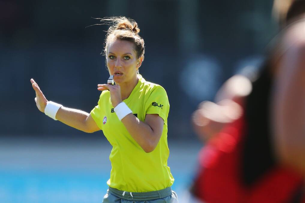 PIONEER: Eleni Glouftsis in action as the first female field umpire in an AFL pre-season match. She steps up to the game's highest level for Essendon-West Coast at Etihad Stadium on Sunday. Picture: Getty Images