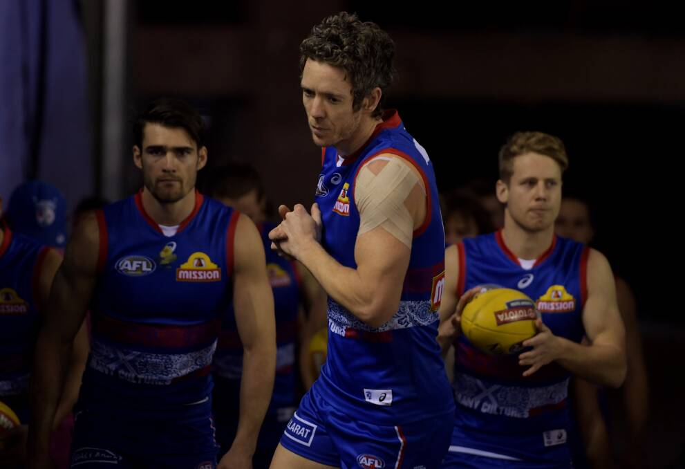 ACTION: Western Bulldogs will run out determined to deliver AFL to Ballarat and to build on hard work in developing community programs. Picture: AAP Image