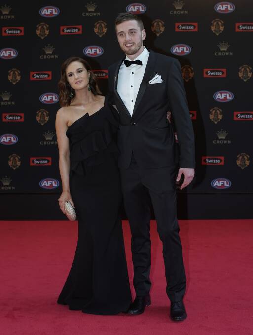 Jordan Roughhead of the Western Bulldogs and his partner Bridget Davies pose for photos on arrival at the Brownlow medal ceremony at Crown in Melbourne on Monday night.