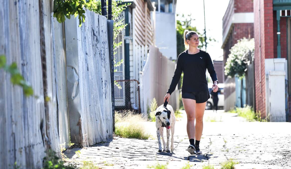 PAW POWER: Western Bulldogs AFLW captain Katie Brennan, an Active April ambassador, takes the lead with her dog Yoncè. Picture: Joe Armao