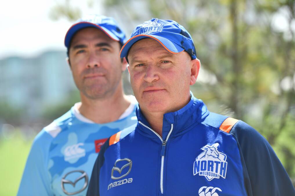 LESSON: North Melbourne's VFL coach David Loader flanked by Kangaroos head coach Brad Scott. Loader will join Scott in the coaches box for AFLX. Picture: The Age