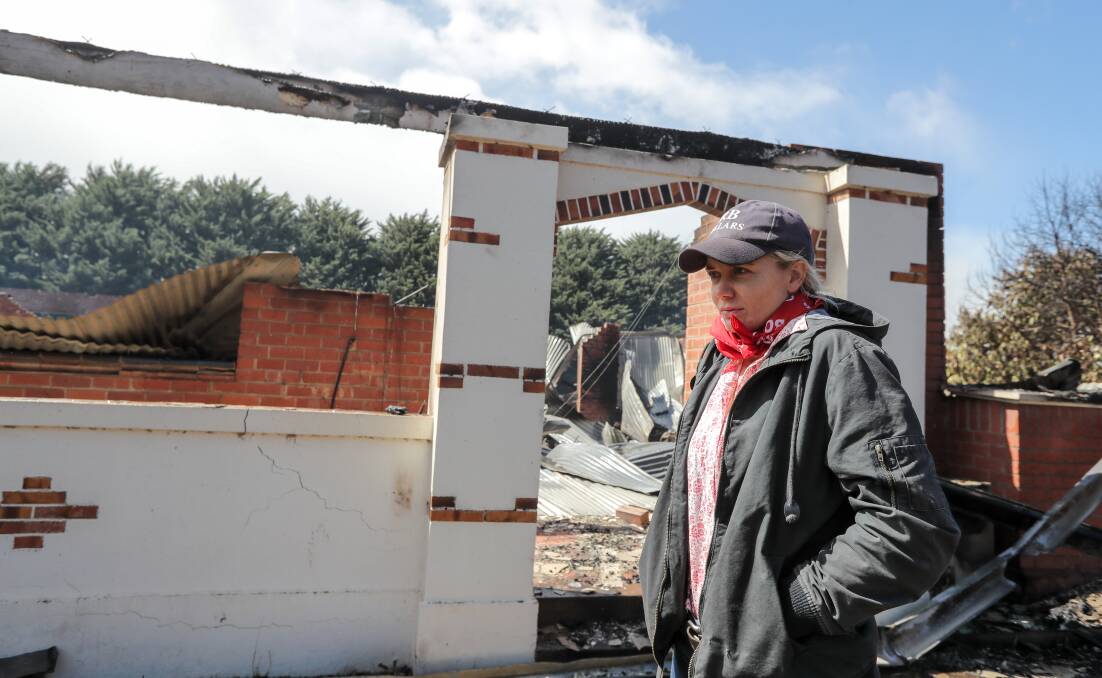 Elle Moyle survey's the remains of her brother's house after a bushfire tore through a settlement south of Penshurst on Saturday night. Picture: Warrnambool Standard