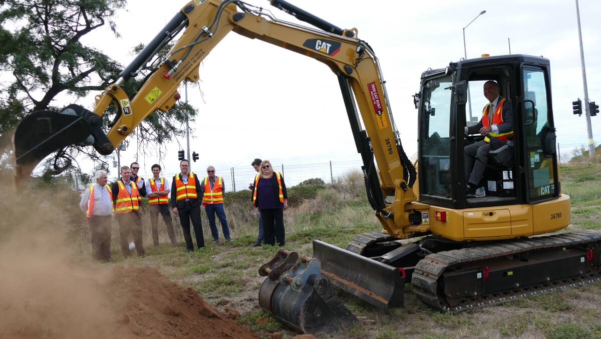 Buninyong MP Geoff Howard turns the first pile of dirt on the Gisborne Road and Holts Lane upgrade in Bacchus Marsh