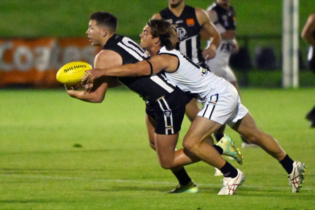 Billy Myers (Darley) is tackled by Malachi White of North Ballarat in the clash at Mars Stadium on Saturday night. Picture by Kate Healy 