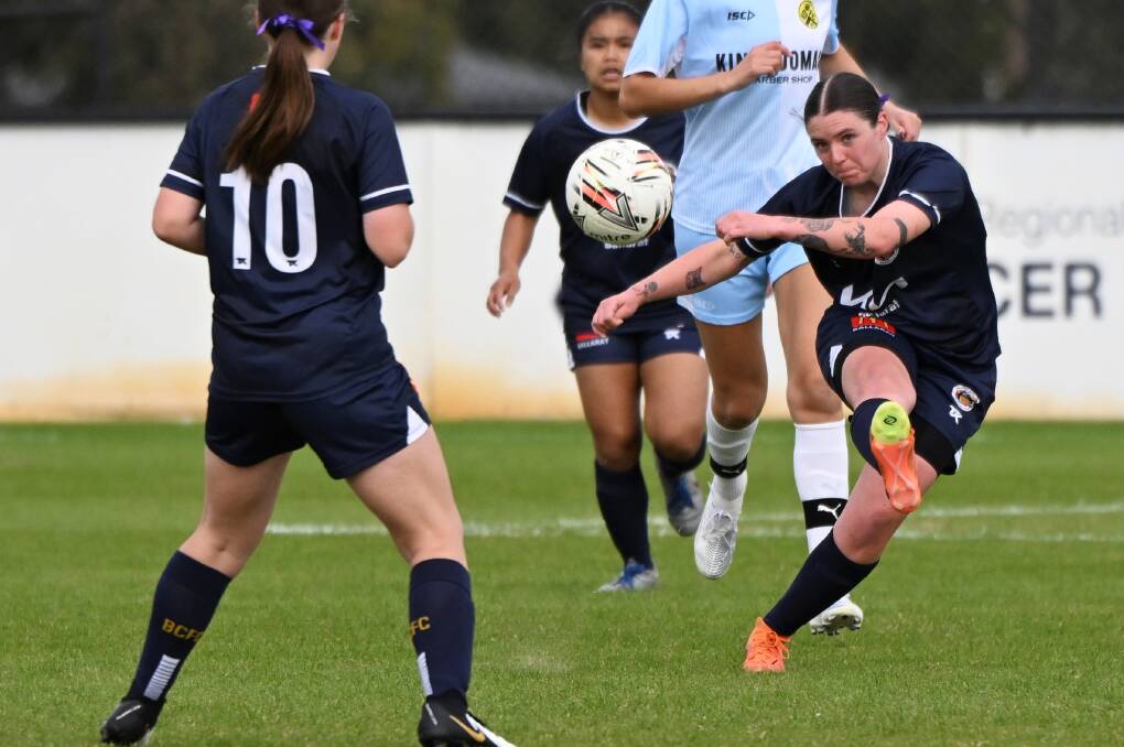 Amy Whiting of Ballarat City athletically gets her kick away against King's Domain. Picture by Lachlan Bence