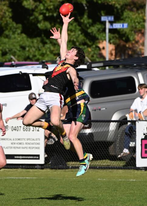 Isaac Nixon of Bacchus Marsh stretches for the ball against Lake Wendouree. Picture by Lachlan Bence