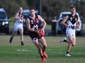 Melton's Lachlan Watkins looks for an option down forward. Picture by Kate Healy