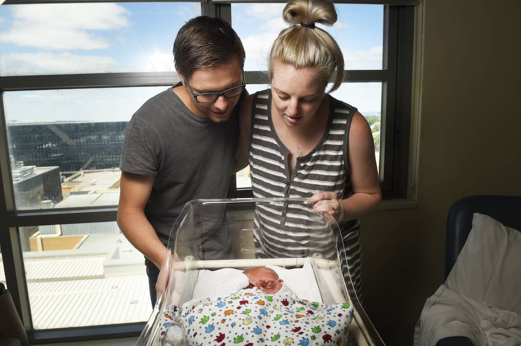 Brendan Wilcox and Tegan Hynes with their baby boy Arlo Wilcox. Picture: Luka Kauzlaric.