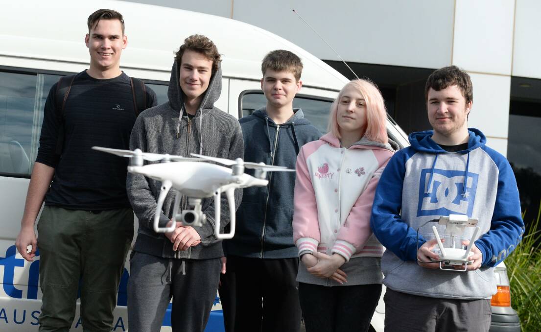 FLY: Federation College P-Tech students Harry McArthur, Schaefer Loges, Zack Morris, Calla Taylor and Brandon Close at their drone mail drop-off at Mount Helen on Wednesday. Pictures: Kate Healy.