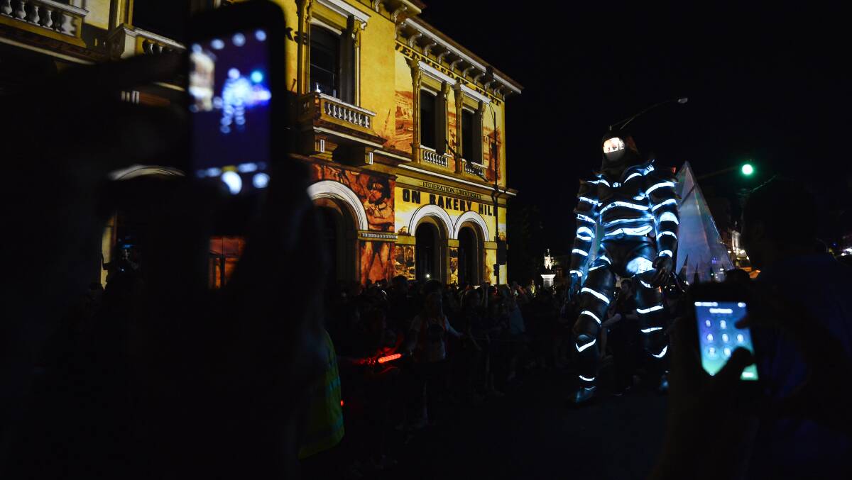 White Night: The White Night Messenger transfixed the crowds on Saturday night as it strode down Lydiard and Sturt Streets. The Knight was puppeteered by a crew and surrounded by a ring of security. Picture: Dylan Burns. 
