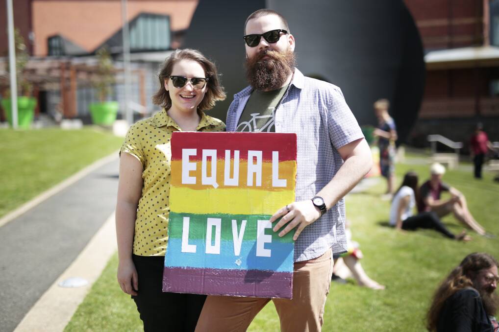 Equal love: Polly Chalke and Alex Clements-Tyler at Saturday's gay pride rally on Camp Street. Attendees wore rainbow and held signs in support of equal love.