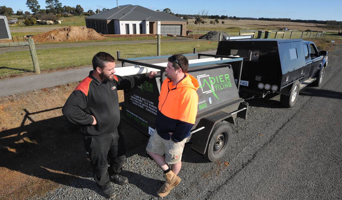 Good Will: Tiler Hayden Bladier will repair defects in Steve Bridgman's home for free. Mr Bladier has lost money to rogue builders before and says he is a "big believer" in paying good will forward. Picture: Lachlan Bence. 