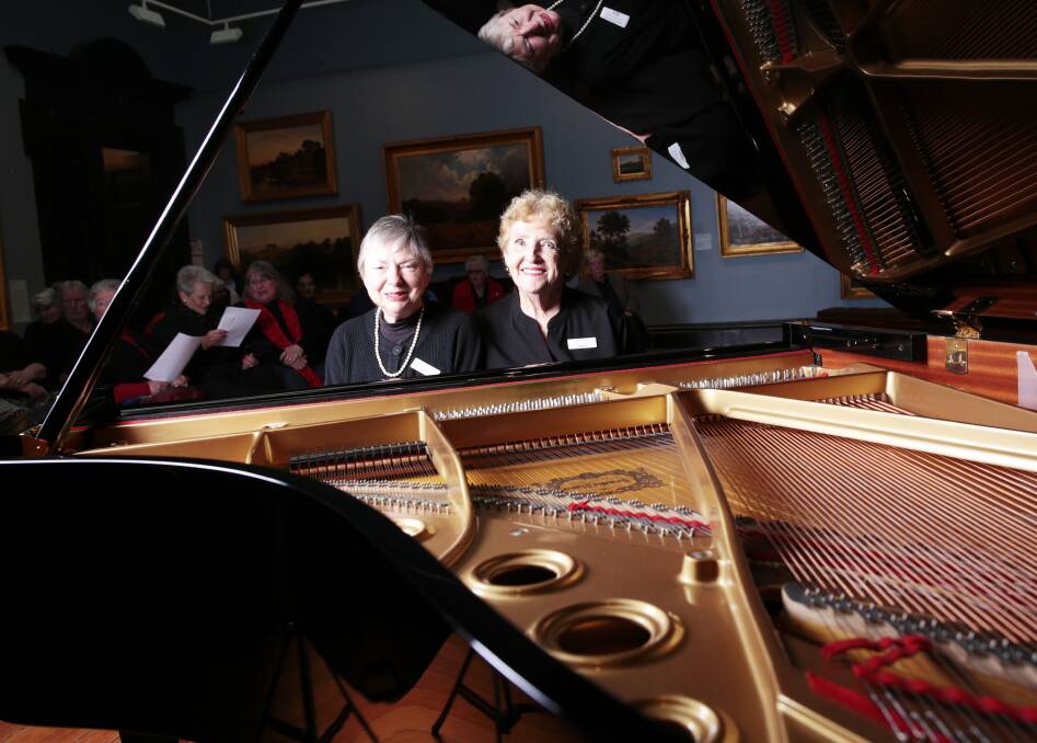 Tuned in: Ballarat Fine Art Gallery Women's Association's Jill Harvey and Janet Lowe-McCulloch with the gallery's new piano. Picture: Luka Kauzlaric.