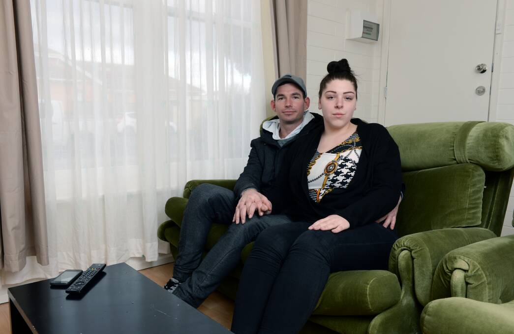 Heating: Chris White and Chelsea McKean in their new apartment, which takes hours to heat. Picture: Kate Healy. 