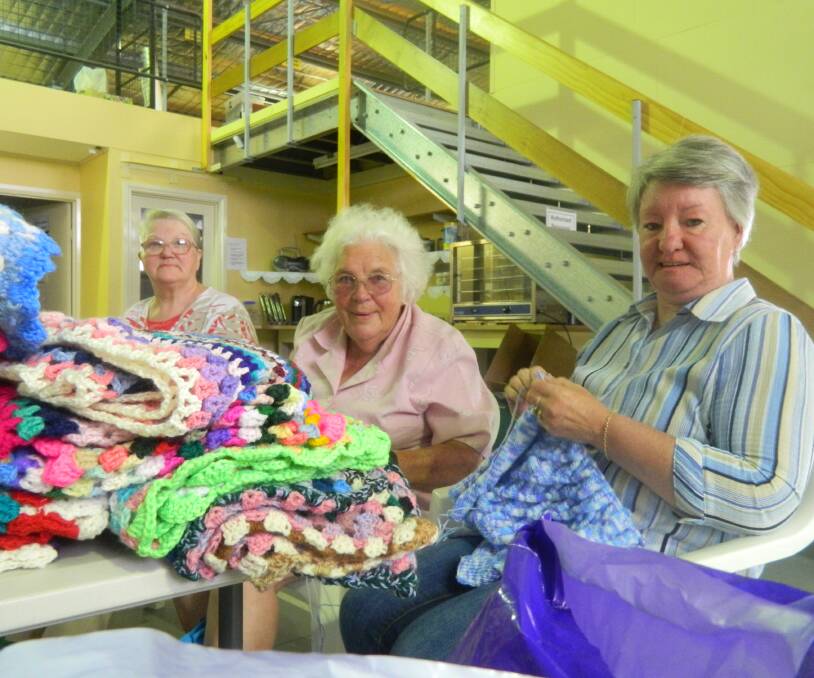 OPERATION COVER-UP: From left to right, Ida Brand, Thea Berry and Pam Coad using their knitting skills to help people battling a harsh European winter. Picture: Louis Gillett.