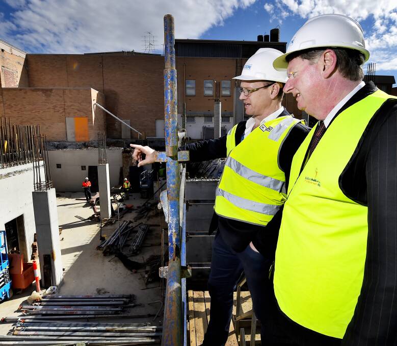 Progress: Ballarat Health Services capital building projects manager Gerard Kennedy and corporate services executive director Russell Hardy take a look at the site in Drummond Street. Picture: Luka Kauzlaric