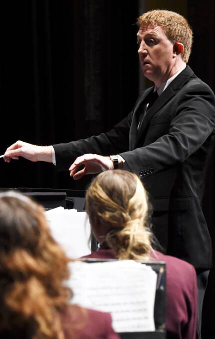 Leading: Matthew Angus conducts the Ballarat Memorial Concert Band at Her Majesty’s Theatre during the Victorian Band Championships. Picture: Lachlan Bence