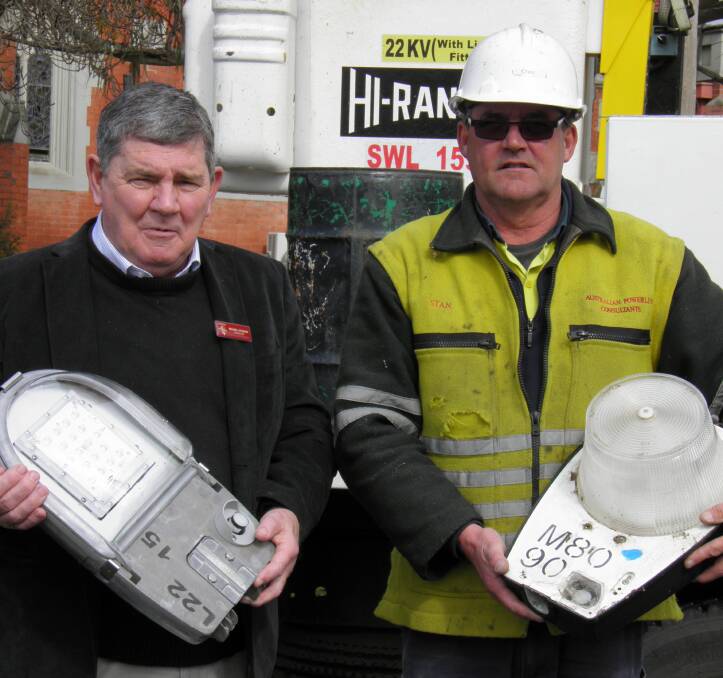 Let there be light: Pyrenees Shire councillor Michael O’Connor compares the new and old lights with Stan Pearce from Australian Powerline Consultants.