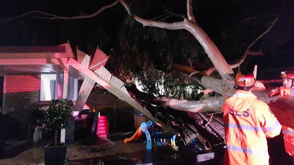 STORM DAMAGE: A house at Capalaba damaged by a tree falling during the storm.
