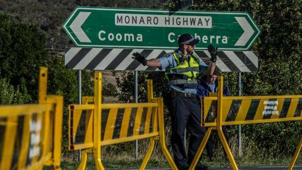 ACT Police conduct road traffic management near the scene of the fatal accident involving a cyclist and a car on the Monaro Highway. Photo: Karleen Minney
