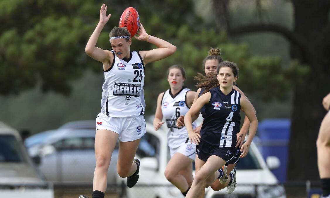 HEADY PLAY: Georgia Clarke peforms a balancing acting in this contest for possession in TAC Cup Girls on Sunday. Picture: Dylan Burns