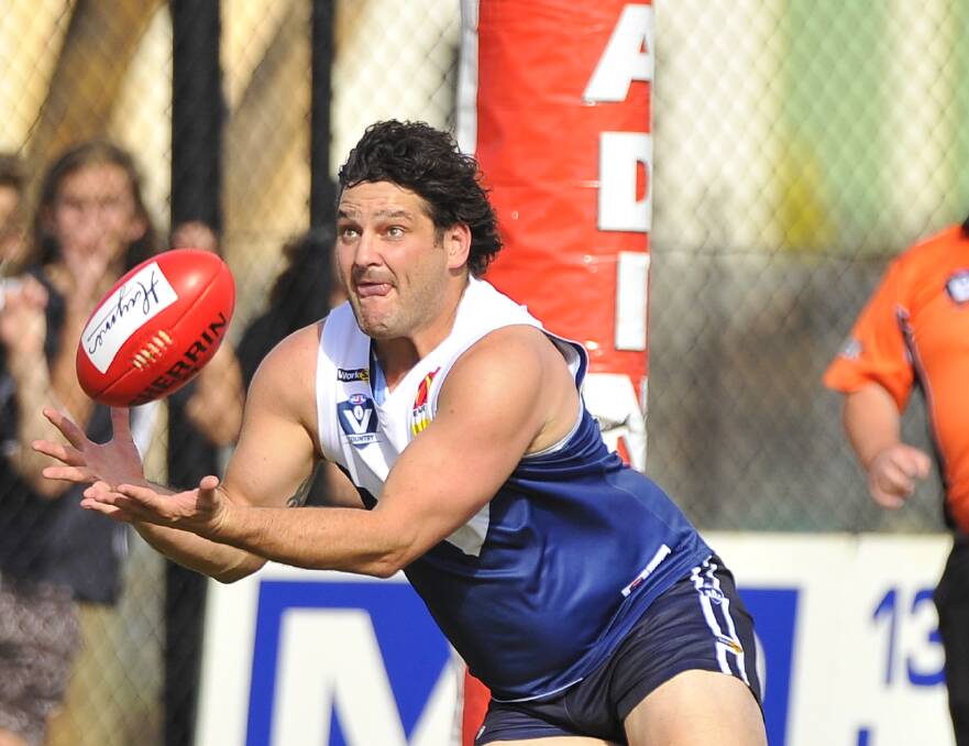 ATTRACTION: Brendan Fevola lunges forward to take a strong mark in a big first quarter by the new Melton South joint coach and spearhead. 