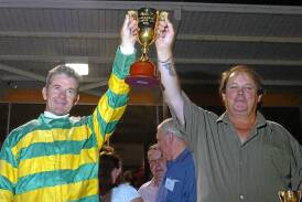 Peter Tonkin and reinsman Gavin Lang celebrate their Ballarat Pacing Cup win witn Robin Hood. Picture by Jeremy Bannister.