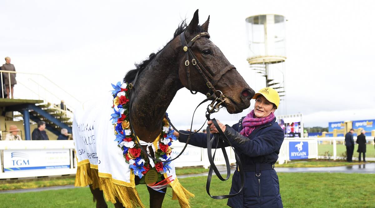 SUPER JUMPER: Geelong trainer Kathryn Durden with champion fencer Wells after winning last year's Grand National Steeplechase in Ballarat. Can he make it three wins in the race on Sunday?