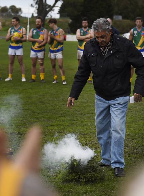 SPECIAL FOCUS: Ballarat Aboriginal elder Ted Lovett performs a smoking ceremony at Marty Busch Reserve on Saturday. Picture: Luka Kauzlaric  