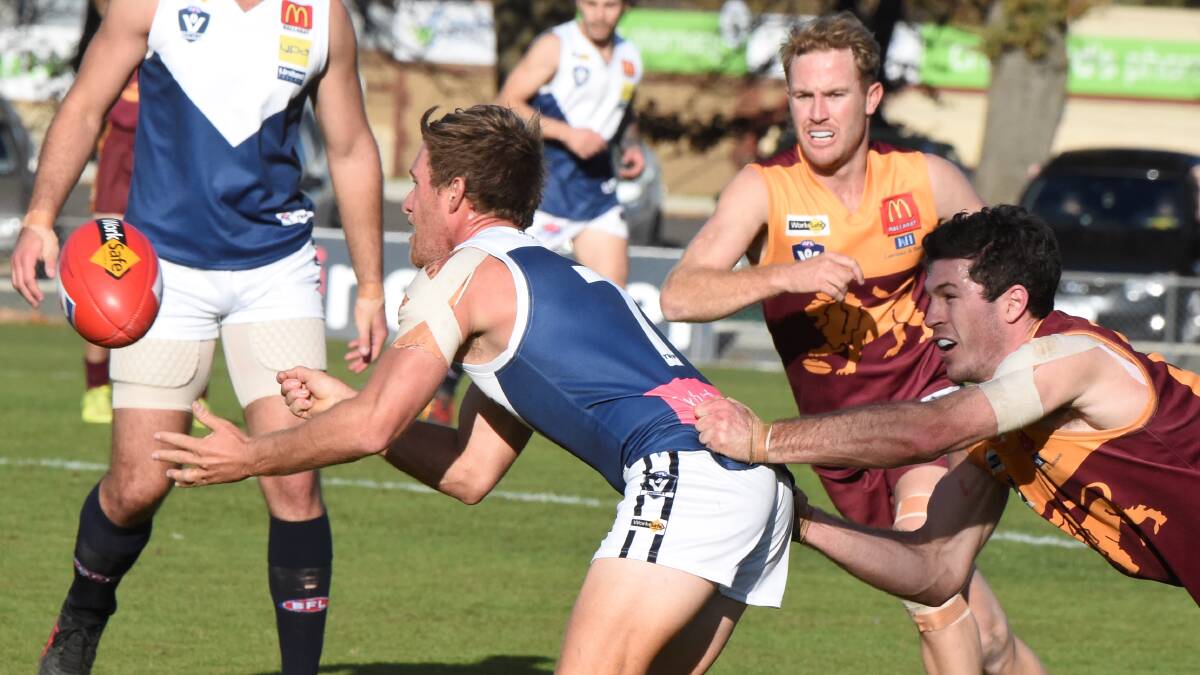 Redan captain Liam Hoy gets hold of Anthony Hibbert (Melton South) at the City Oval on Saturday - just as the Lions got hold of the Panthers. Picture: Lachlan Bence.