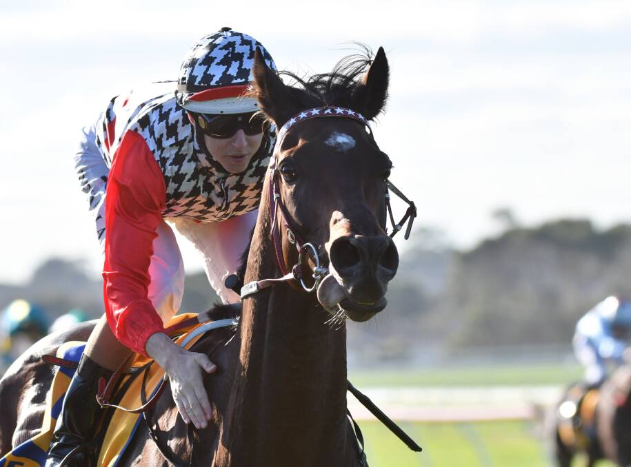 GOOD BOY: Damian Lane gives High Church a big pat as they
cross the line in the Warrnambool Cup. Picture: Getty Images